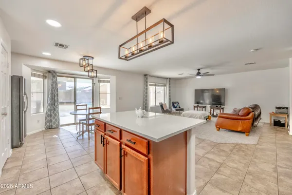 a large kitchen with kitchen island a sink and a stove