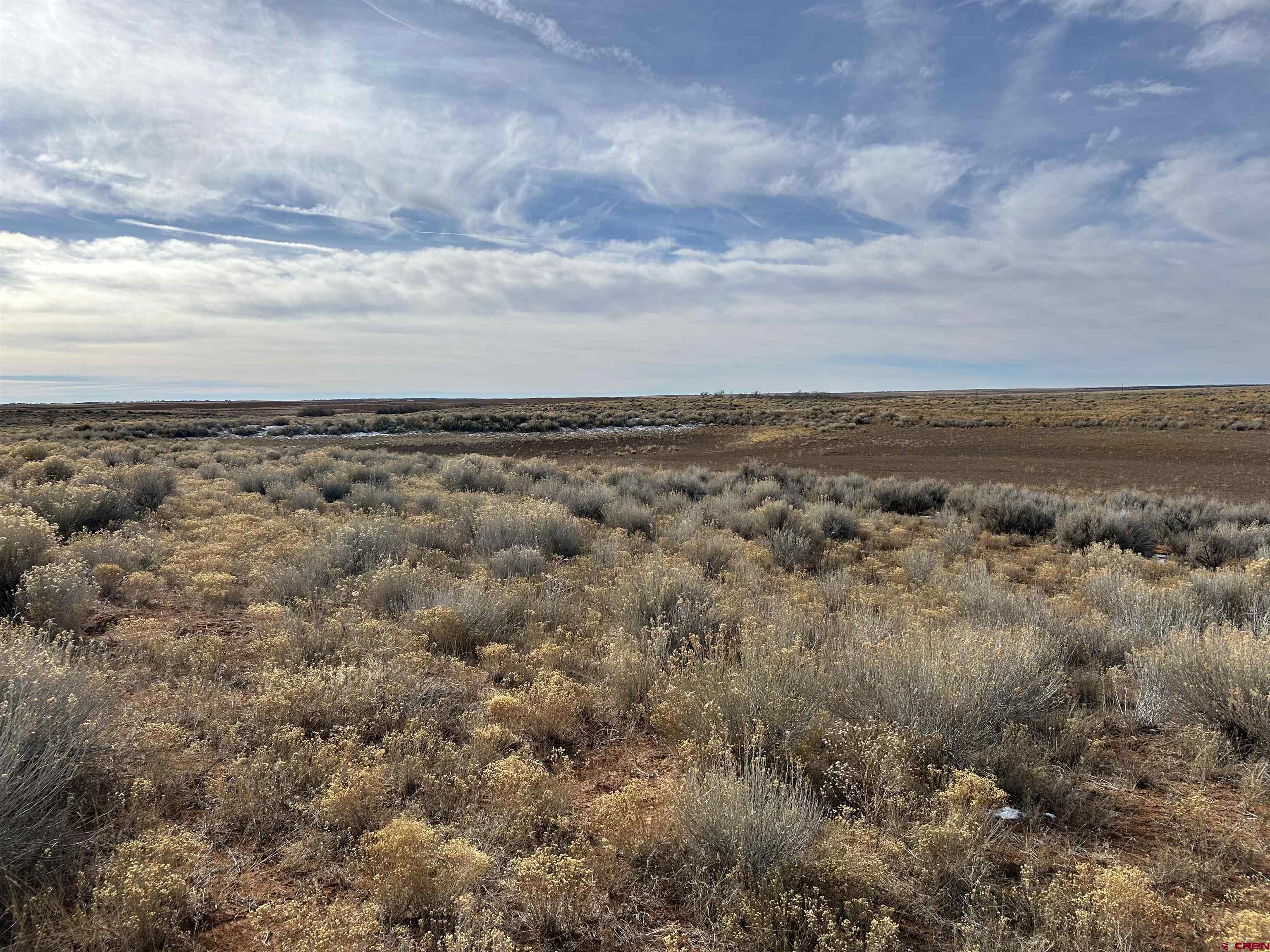 6462 Rd L Dove Creek, CO 81324 - Photo 5 of 28 an aerial view of houses covered with fog