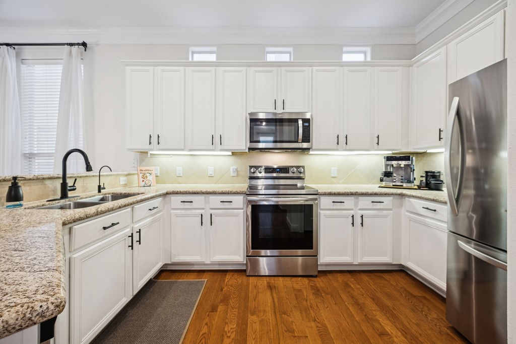 5737 Kansas Street Houston, TX 77007 - Photo 19 of 47 a kitchen with granite countertop a refrigerator sink and white cabinets