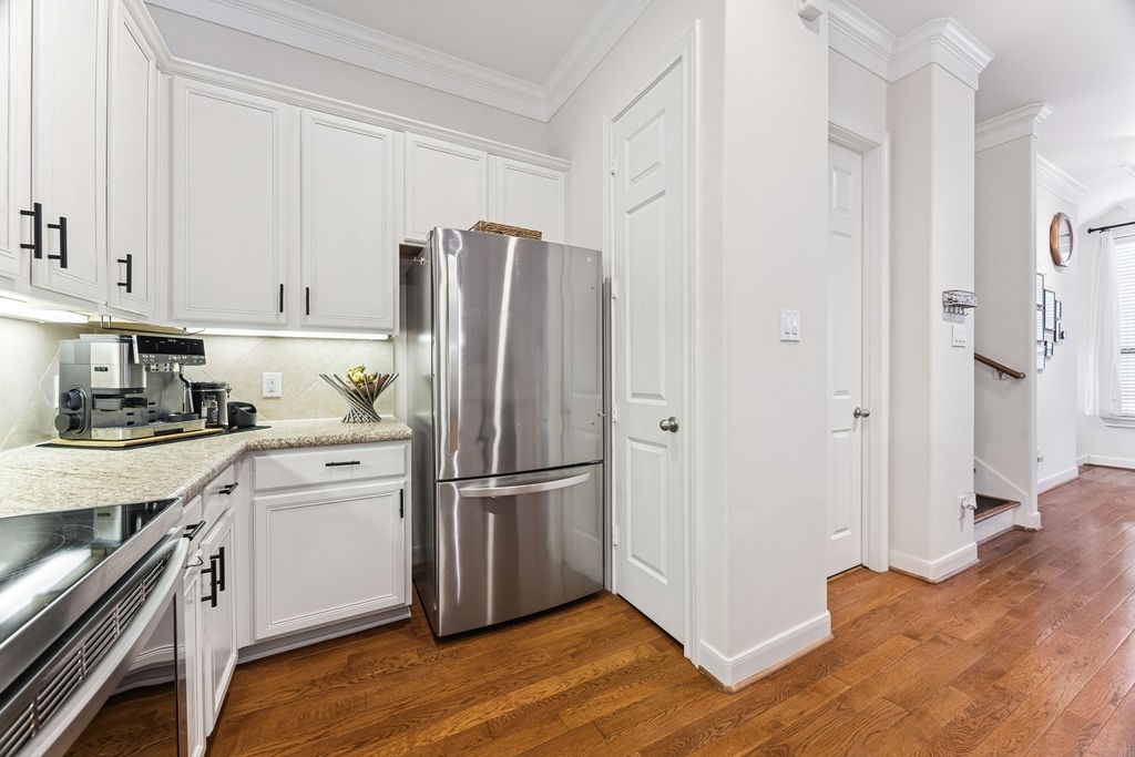 5737 Kansas Street Houston, TX 77007 - Photo 21 of 47 a kitchen with a refrigerator and cabinets
