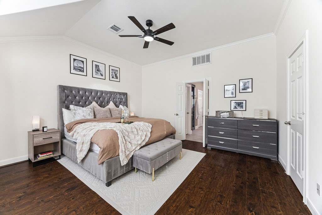 5737 Kansas Street Houston, TX 77007 - Photo 27 of 47 a bedroom with a bed and a ceiling fan