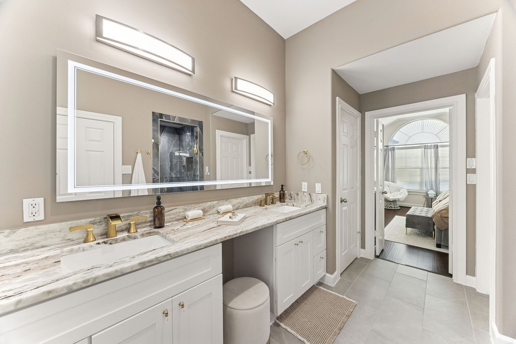 5737 Kansas Street Houston, TX 77007 - Photo 32 of 47 a spacious bathroom with a granite countertop sink mirror and double