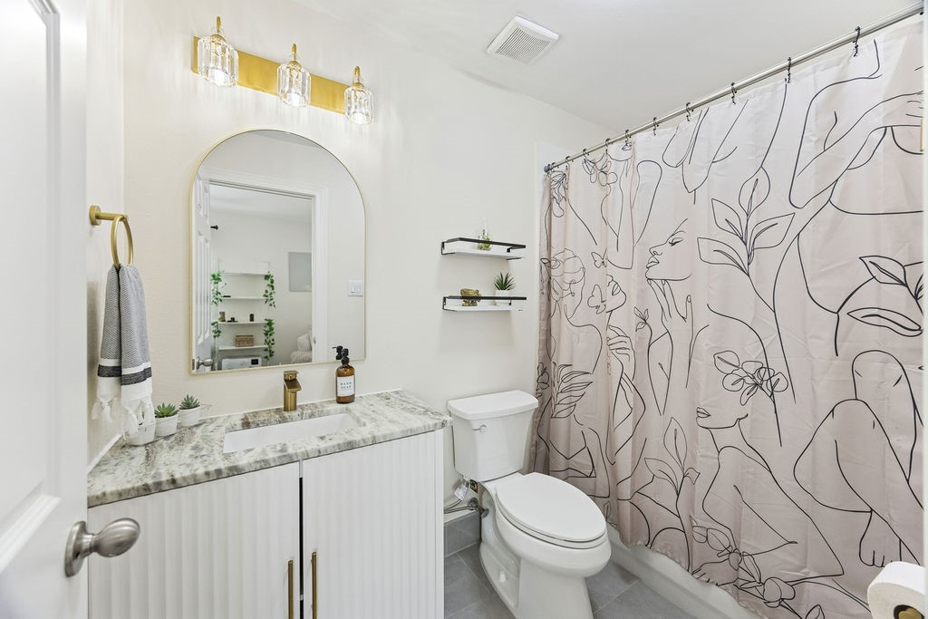 5737 Kansas Street Houston, TX 77007 - Photo 39 of 47 a bathroom with a granite countertop sink and a mirror