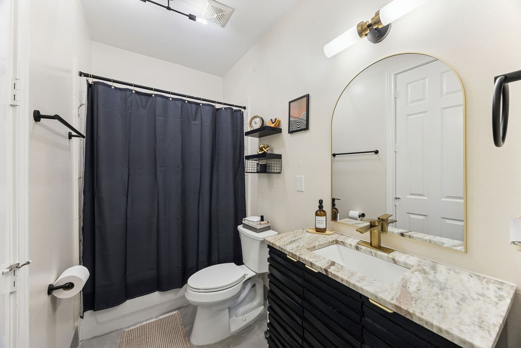 5737 Kansas Street Houston, TX 77007 - Photo 8 of 47 a bathroom with a granite countertop sink toilet and shower