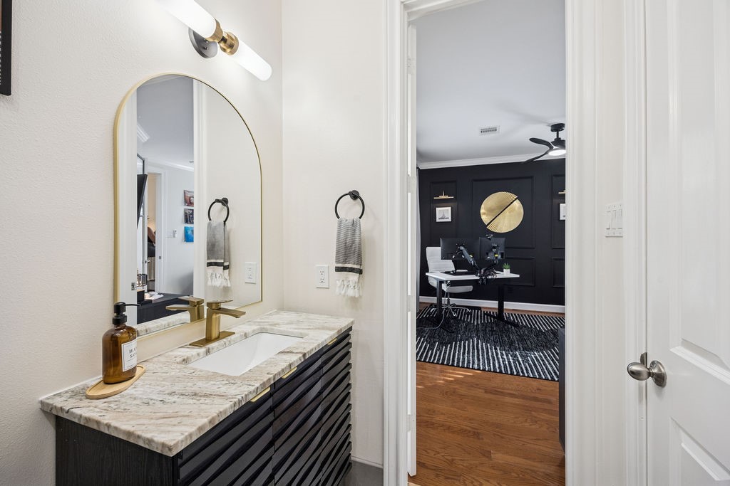 5737 Kansas Street Houston, TX 77007 - Photo 9 of 47 a bathroom with a granite countertop sink a mirror and vanity