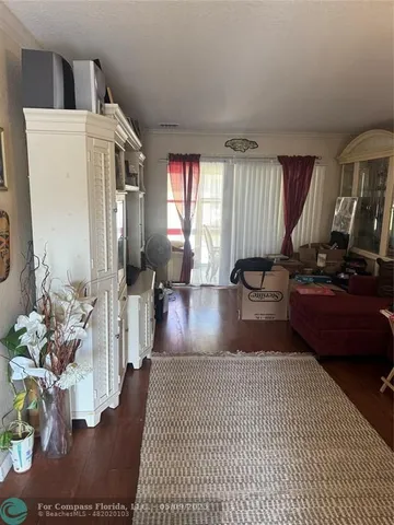a view of living room filled with furniture window and a table