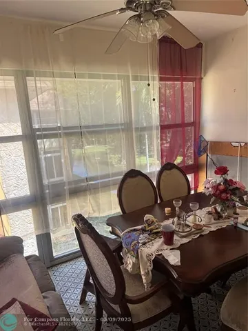 a living room with furniture chandelier and a window