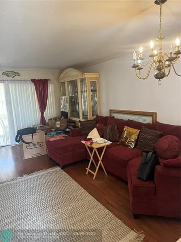 a kitchen with stainless steel appliances a stove a microwave a sink and cabinets