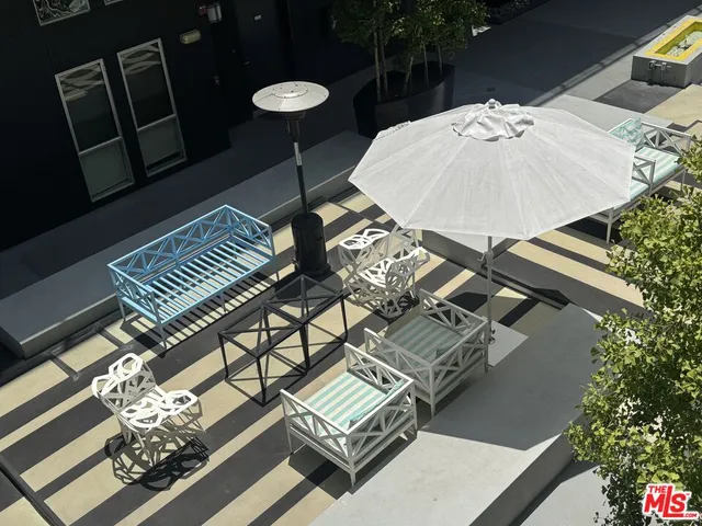 a view of a building with sitting area and furniture