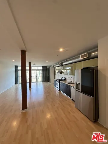 a large kitchen with a stove and a refrigerator