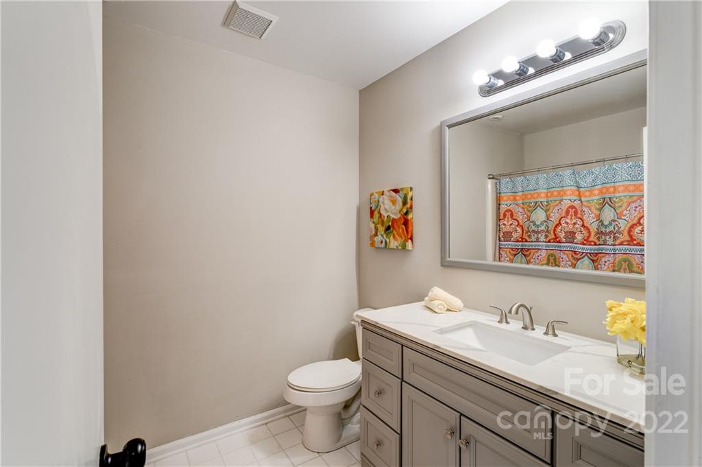 3088 Point Clear Drive Tega Cay, SC 29708 - Photo 12 of 32 a bathroom with a granite countertop sink and a mirror