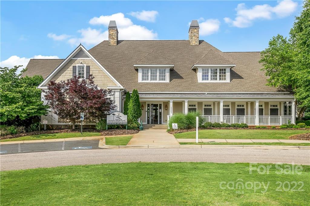 3088 Point Clear Drive Tega Cay, SC 29708 - Photo 27 of 32 a front view of a house with a garden and plants