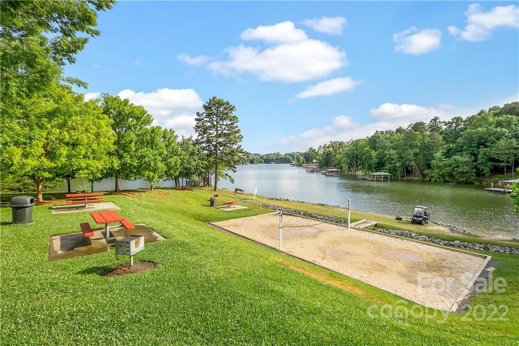 3088 Point Clear Drive Tega Cay, SC 29708 - Photo 30 of 32 a view of a lake with a yard and a wooden fence