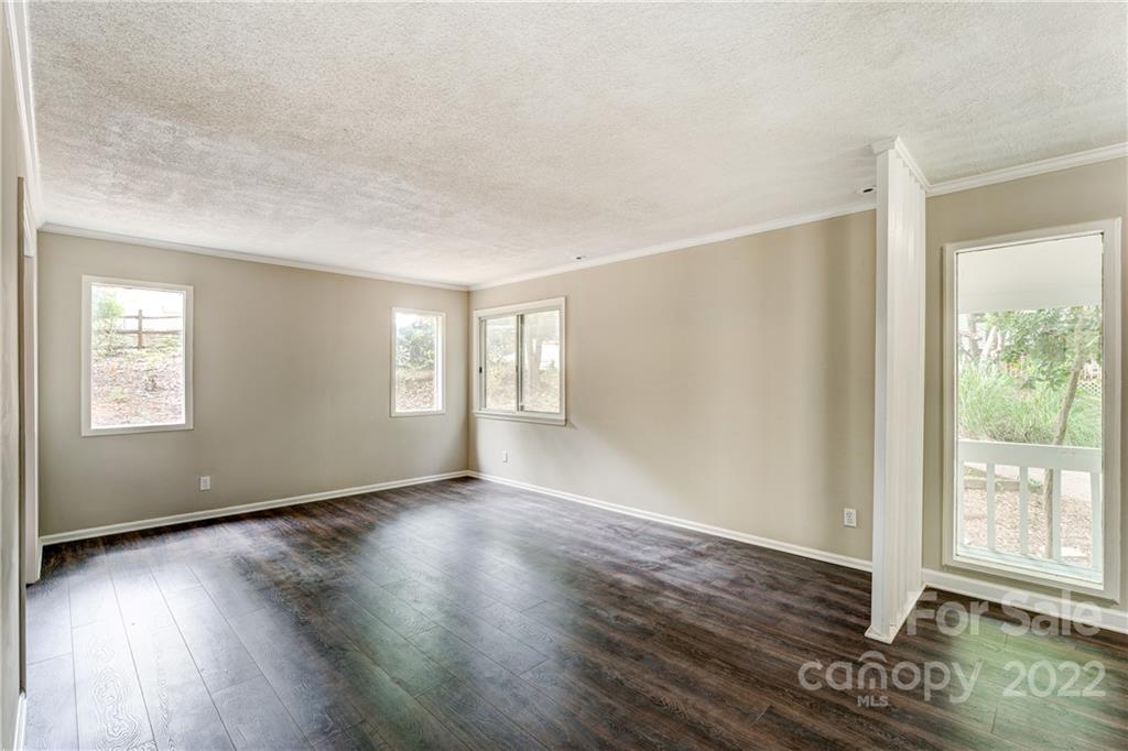 3088 Point Clear Drive Tega Cay, SC 29708 - Photo 5 of 32 a view of an empty room with wooden floor and a window