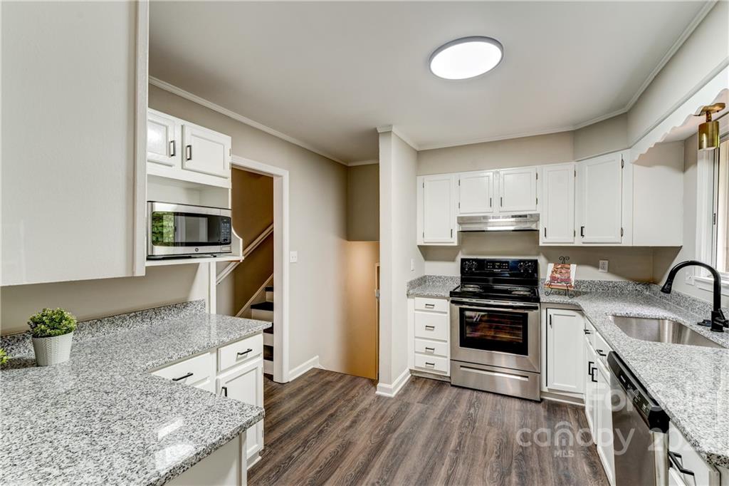 3088 Point Clear Drive Tega Cay, SC 29708 - Photo 8 of 32 a kitchen with stainless steel appliances granite countertop a stove sink and cabinets