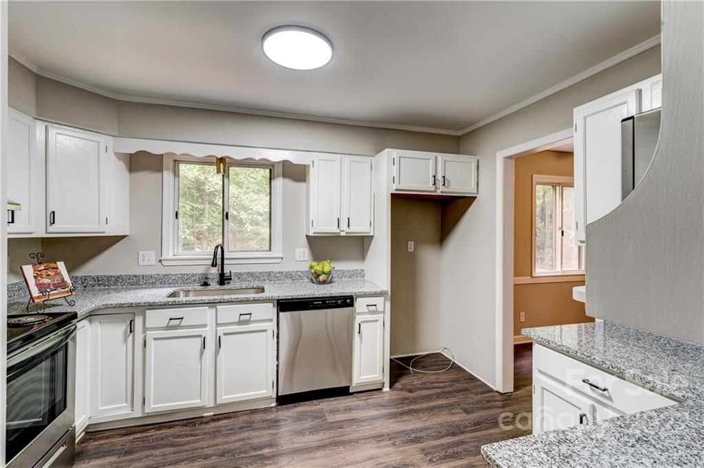 3088 Point Clear Drive Tega Cay, SC 29708 - Photo 9 of 32 a kitchen with stainless steel appliances granite countertop a sink stove and refrigerator
