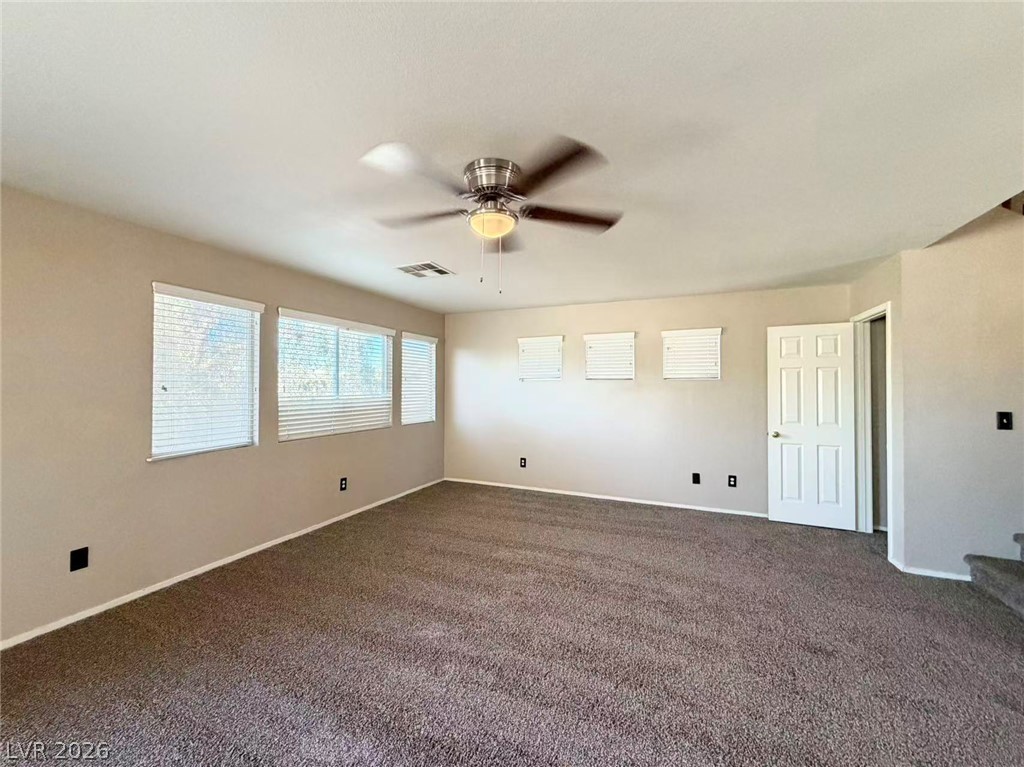 920 Hunters Ridge Way North Las Vegas, NV 89032 - Photo 3 of 16 Plentiful windows line this comfortable carpeted room, welcoming abundant natural light throughout.