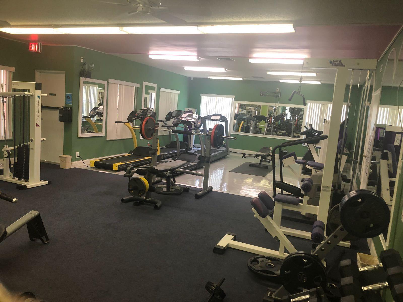 a room with gym equipment and a view of living room