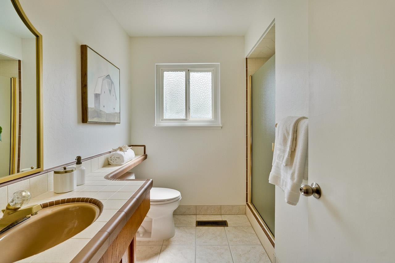 592 Torland Court Sunnyvale, CA 94087 - Photo 25 of 51 a bathroom with a sink and mirror with toilet