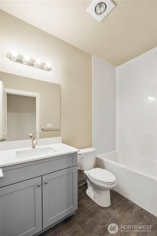 a white toilet sitting next to a bathroom sink