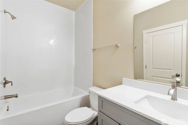 a bathroom with a sink a toilet and bathtub