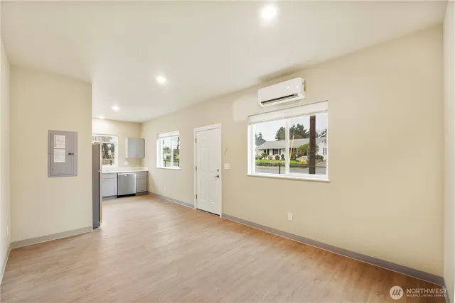 an empty room with windows and entrance