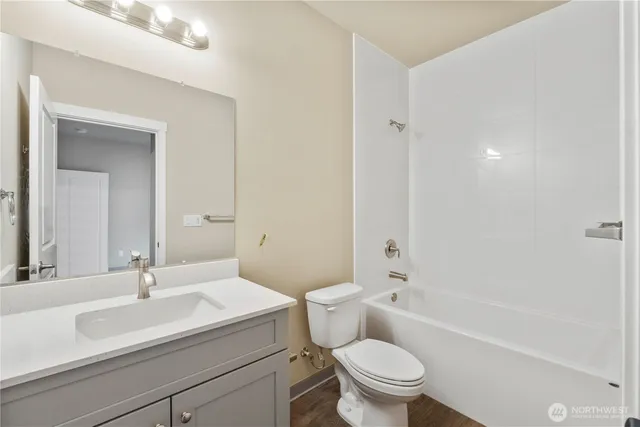 a bathroom with a sink a toilet and a large mirror