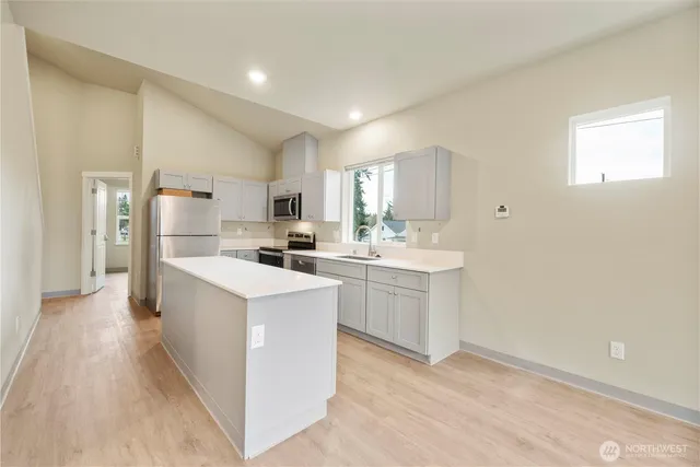 a kitchen with refrigerator and cabinets