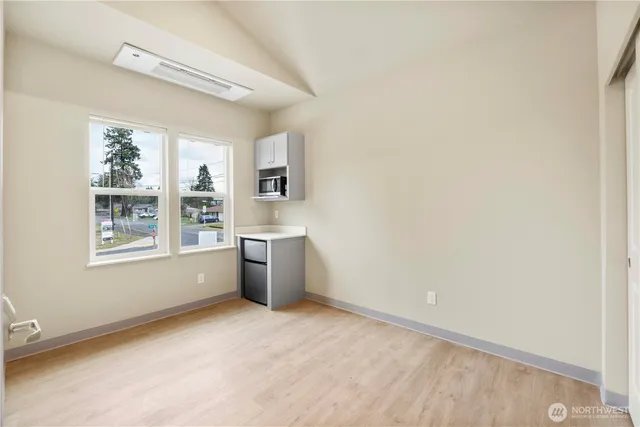 a view of a kitchen with microwave and windows