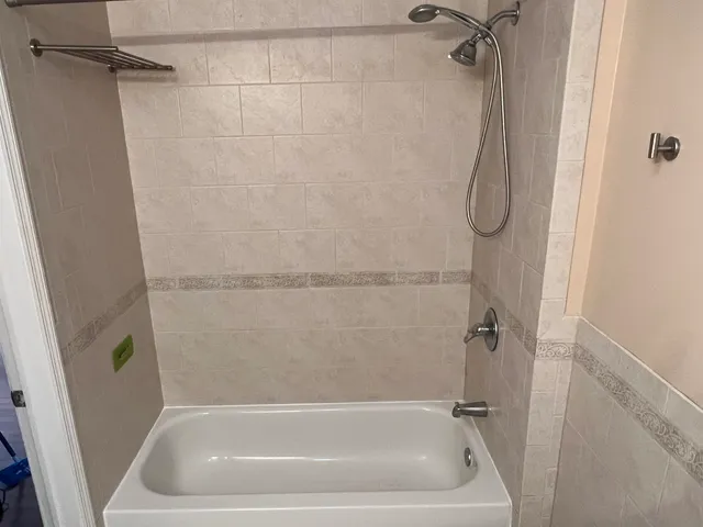 a bath tub sitting next to a shower