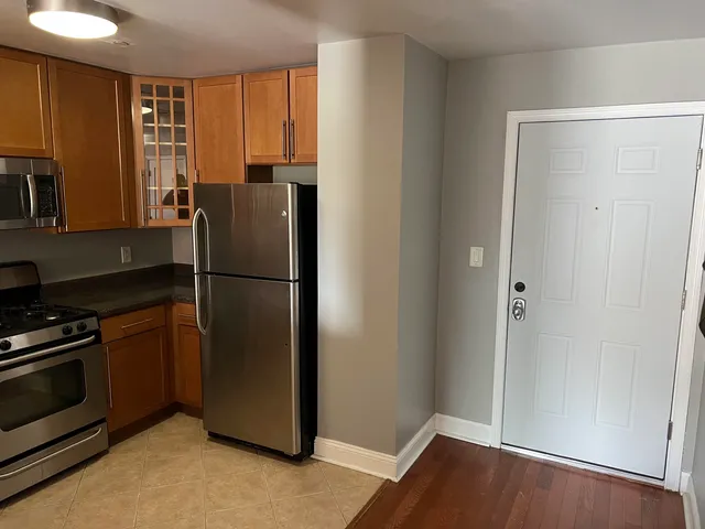a kitchen with a refrigerator cabinet and a sink