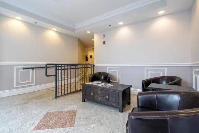 a living room with furniture and a lamp