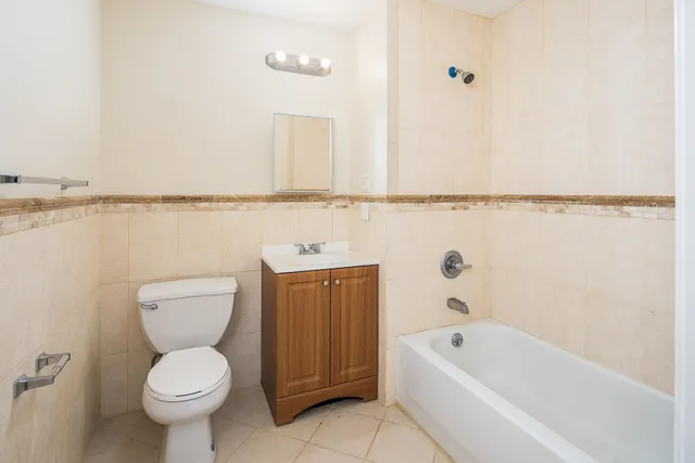 a bathroom with a toilet a sink and bathtub