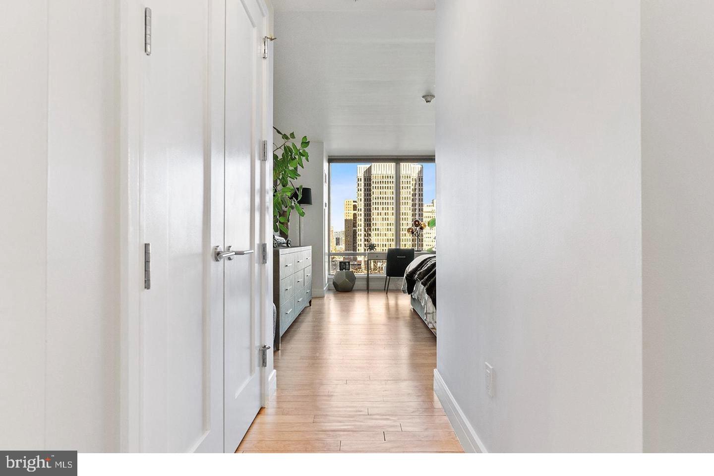 1414 South Penn Square, Unit 7F Philadelphia, PA 19102 - Photo 12 of 30 a view of a hallway with wooden floor fireplace and living room