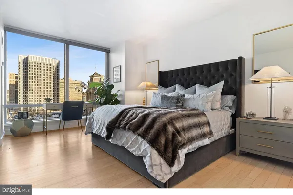 a spacious bedroom with a bed and a couch