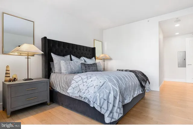 a bedroom with a bed and a lamp