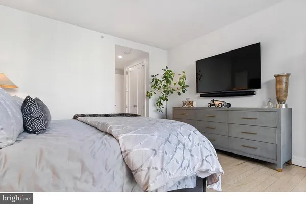 a bedroom with a bed and a flat screen tv