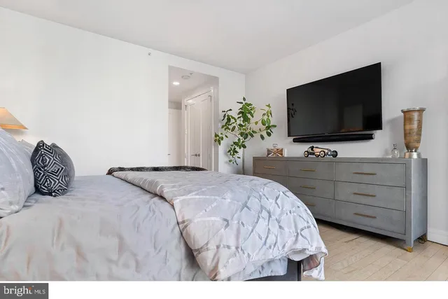 a bedroom with a bed and a flat screen tv
