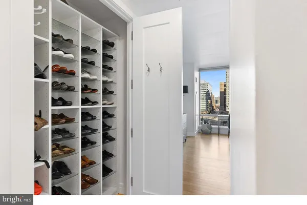 a view of empty room with windows and book shelf