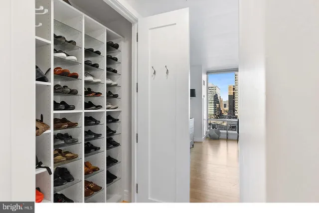 a view of empty room with windows and book shelf