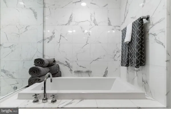 a bathroom with a glass shower door