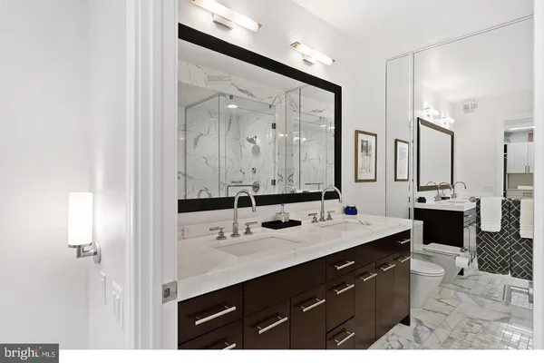a bathroom with a sink double vanity and a mirror