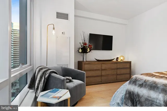 a bathroom with a sink mirror and shower