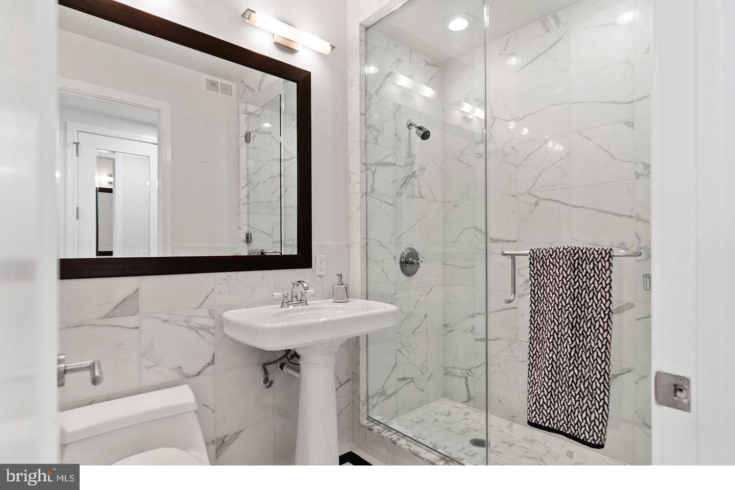 1414 South Penn Square, Unit 7F Philadelphia, PA 19102 - Photo 27 of 30 a bathroom with a sink mirror and shower