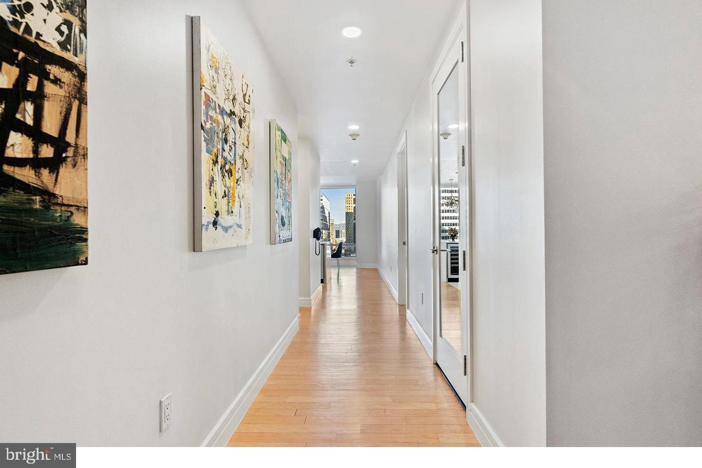 1414 South Penn Square, Unit 7F Philadelphia, PA 19102 - Photo 28 of 30 a view of a hallway with wooden floor and a living room