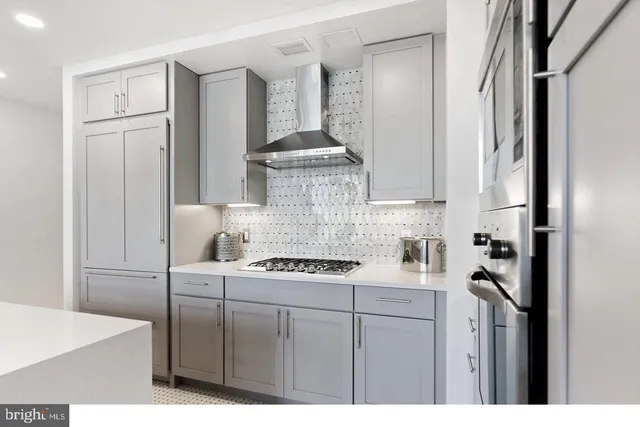 a kitchen with stainless steel appliances granite countertop a stove a refrigerator and a cabinets