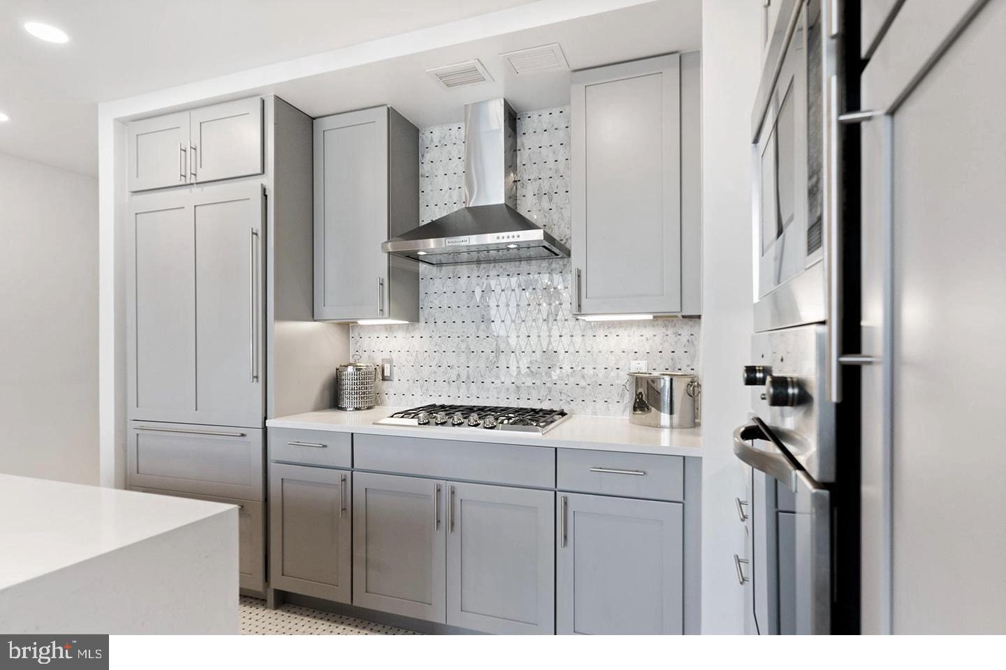 1414 South Penn Square, Unit 7F Philadelphia, PA 19102 - Photo 4 of 30 a kitchen with stainless steel appliances granite countertop a stove a refrigerator and a cabinets