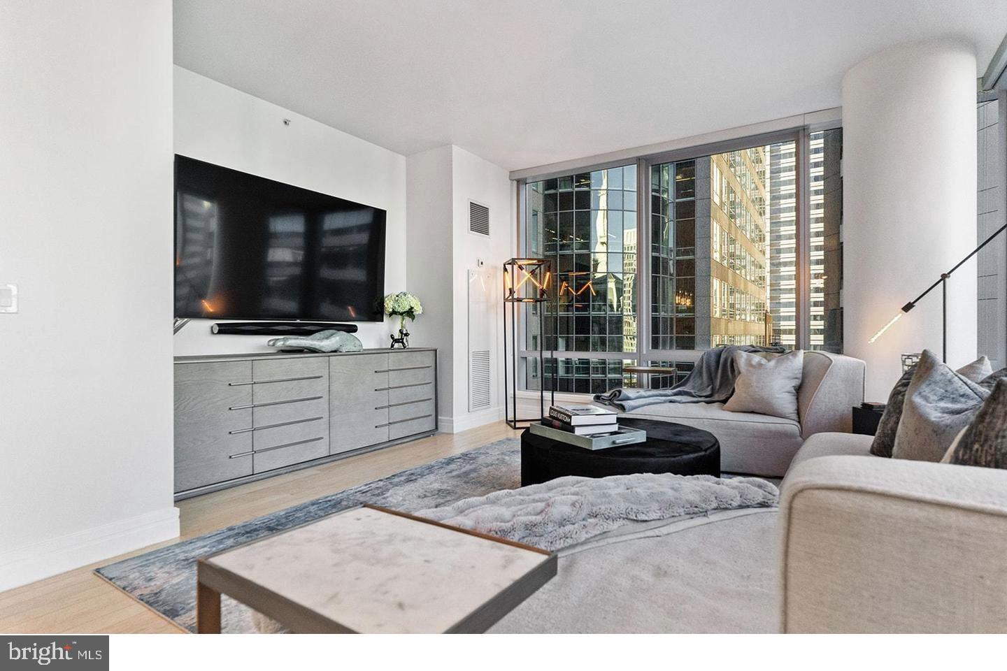 1414 South Penn Square, Unit 7F Philadelphia, PA 19102 - Photo 7 of 30 a living room with furniture and a flat screen tv