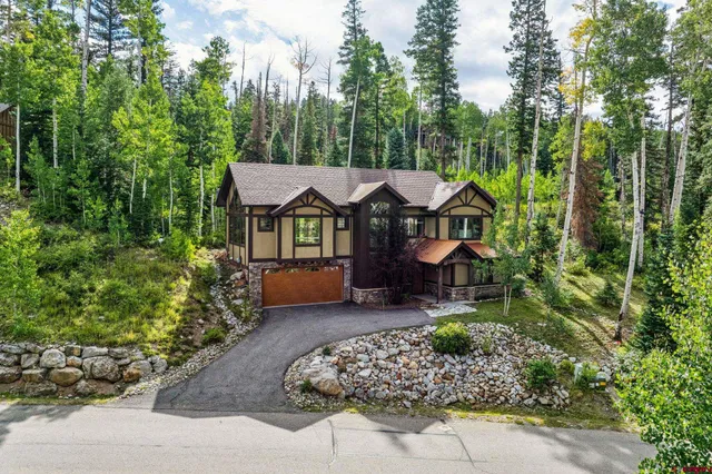a front view of a house with a yard and outdoor seating