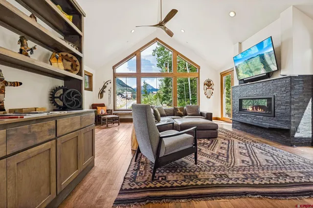 a living room with furniture a flat screen tv and a fireplace